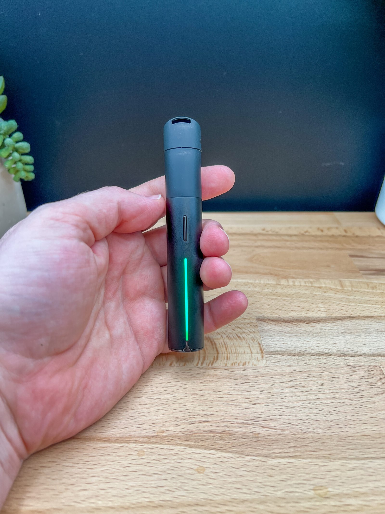 Text: Puffco Pivot dab pen standing upright with mouthpiece removed – Puffco Pivot Review